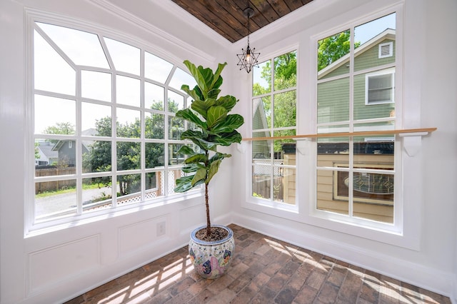 unfurnished sunroom featuring a notable chandelier