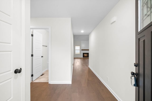 corridor featuring recessed lighting, baseboards, and dark wood-type flooring