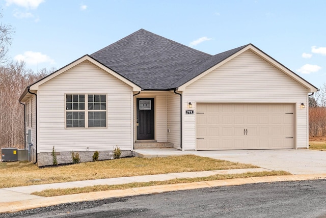 ranch-style home with a shingled roof, an attached garage, cooling unit, and driveway