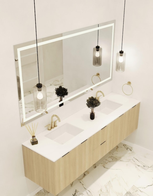 full bathroom featuring baseboards, a sink, marble finish floor, and double vanity