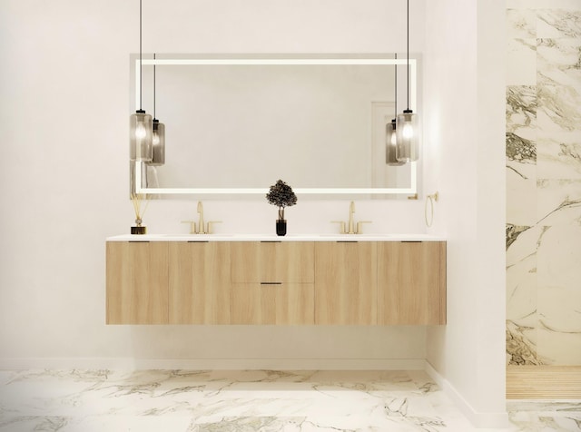 full bath featuring double vanity, a sink, marble finish floor, and baseboards