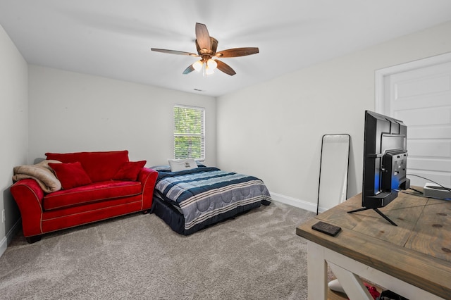 carpeted bedroom with baseboards and a ceiling fan