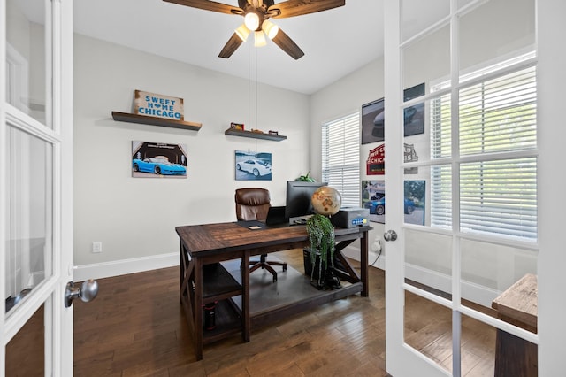 office space with baseboards, a ceiling fan, and dark wood-type flooring