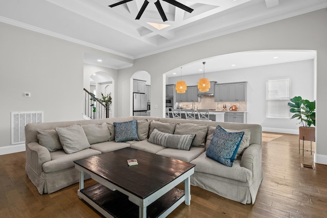 living room featuring beam ceiling, arched walkways, recessed lighting, visible vents, and coffered ceiling