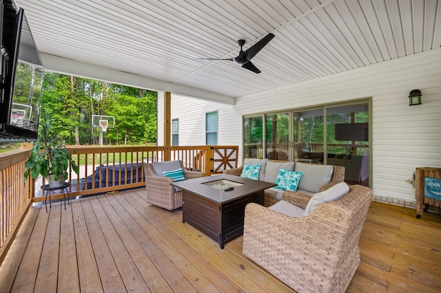 deck with an outdoor living space with a fire pit and ceiling fan