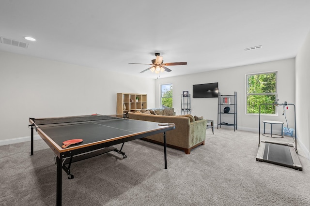 recreation room featuring baseboards, carpet flooring, and a wealth of natural light