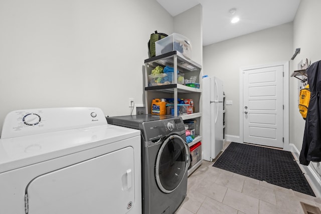 clothes washing area with laundry area and washer and dryer
