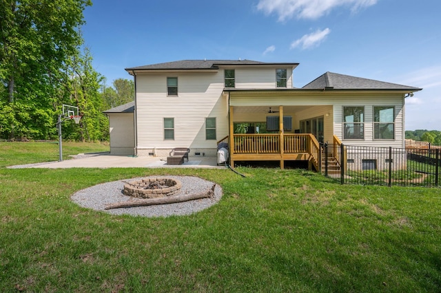 back of property with a fire pit, fence, a deck, a patio, and a yard