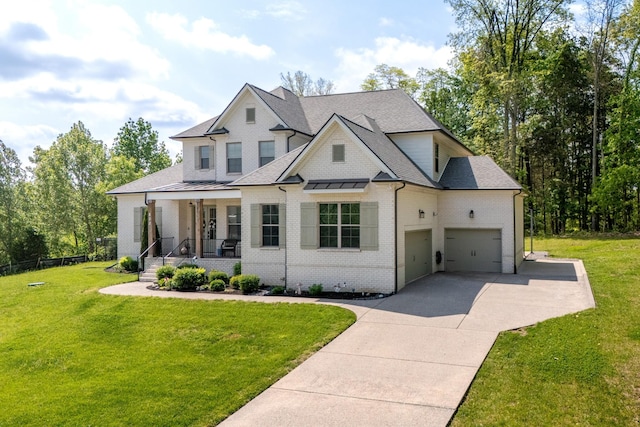 modern farmhouse with an attached garage, brick siding, a front yard, concrete driveway, and covered porch