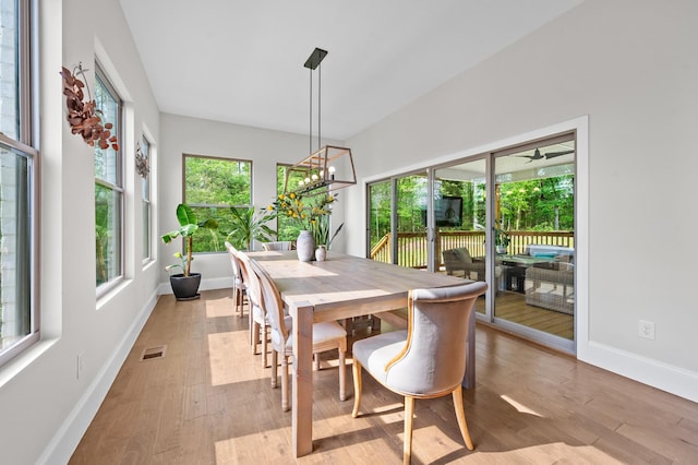dining space with visible vents, light wood-style flooring, and baseboards