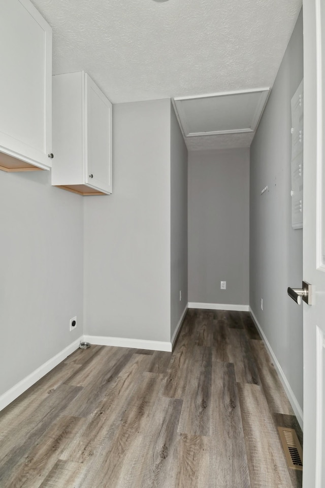 605 Poplar St, Lafayette, TN 37083 - interior space featuring visible vents, attic access, a textured ceiling, and wood finished floors