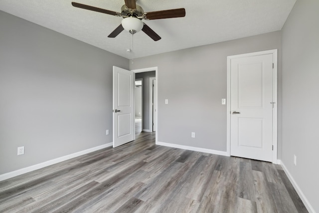 605 Poplar St, Lafayette, TN 37083 - unfurnished bedroom featuring a ceiling fan, baseboards, and wood finished floors