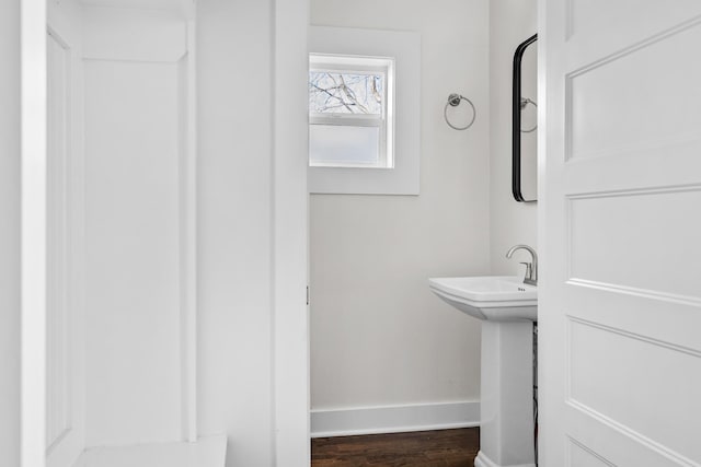 bathroom with baseboards and wood finished floors
