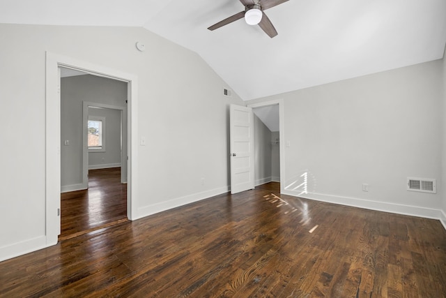 interior space with ceiling fan, visible vents, dark wood-style floors, and lofted ceiling