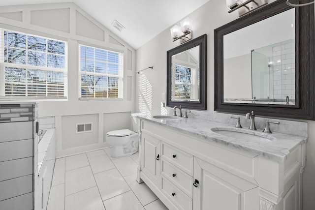 bathroom featuring visible vents, a sink, a garden tub, and lofted ceiling