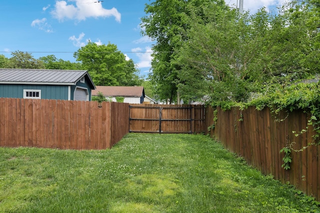 view of yard featuring a fenced backyard and a detached garage