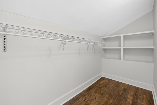 walk in closet featuring dark wood-type flooring and lofted ceiling