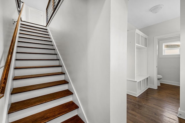 stairway featuring baseboards and wood finished floors
