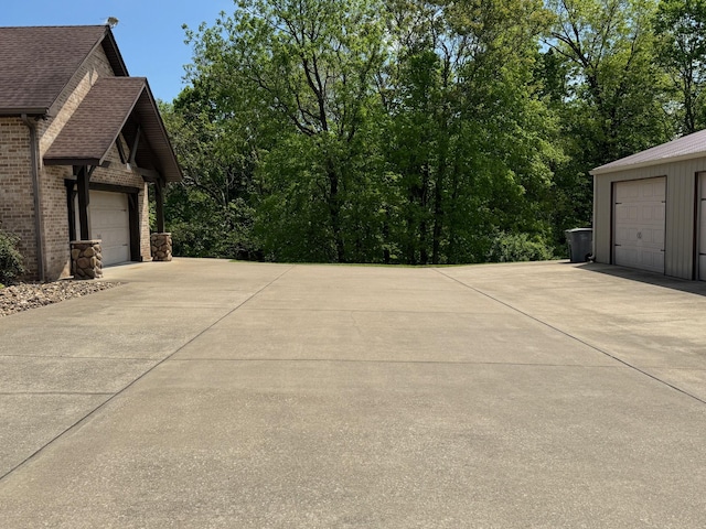 view of home's exterior with a garage and roof with shingles