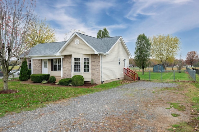 143 Willdon Dr, Portland, TN 37148 - view of front of home with crawl space, a front yard, brick siding, fence, and a shingled roof