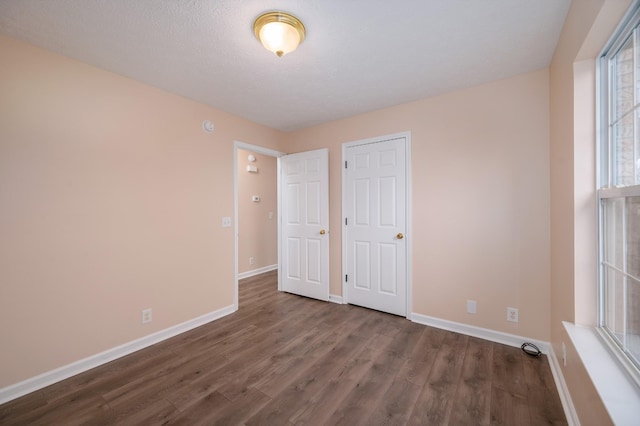 143 Willdon Dr, Portland, TN 37148 - unfurnished bedroom with baseboards and dark wood-type flooring
