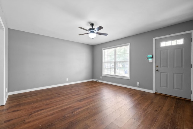 entrance foyer with baseboards, a ceiling fan, wood finished floors, and a healthy amount of sunlight