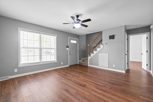 entryway with visible vents, a ceiling fan, stairs, and wood finished floors