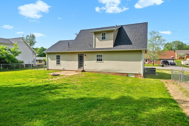 rear view of house with a patio, a fenced backyard, a yard, and entry steps