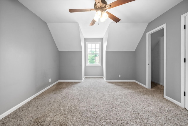 additional living space featuring a ceiling fan, baseboards, vaulted ceiling, and carpet