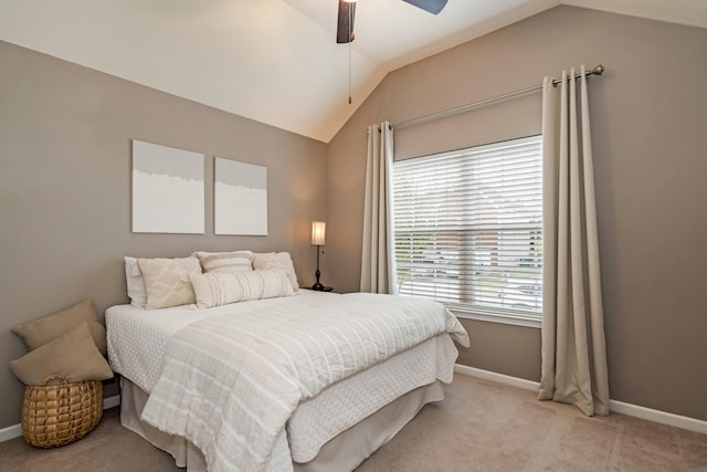 bedroom featuring baseboards, a ceiling fan, light colored carpet, and lofted ceiling