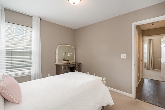 carpeted bedroom featuring baseboards