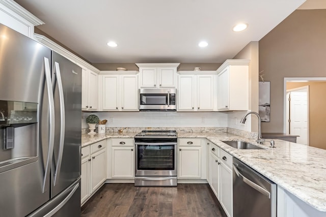 kitchen featuring light stone countertops, appliances with stainless steel finishes, a sink, dark wood finished floors, and white cabinetry