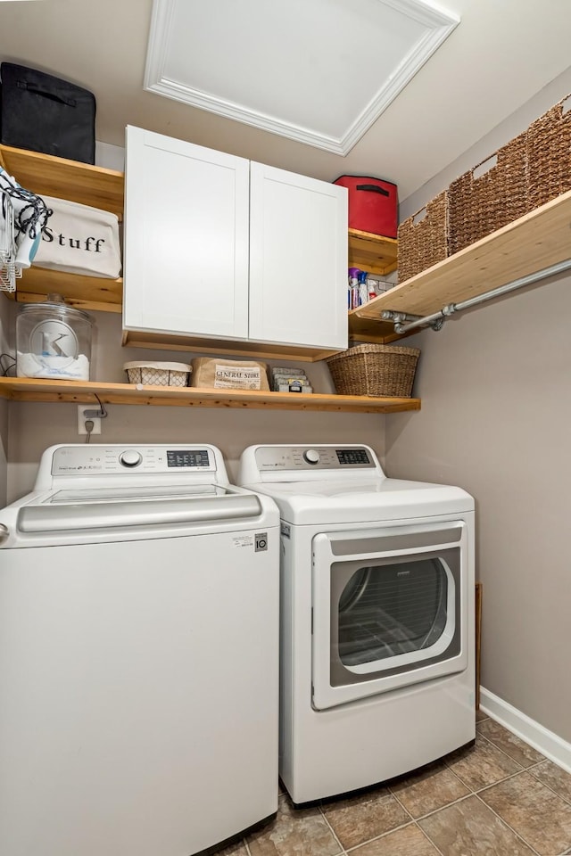 laundry room with baseboards, cabinet space, and washer and dryer