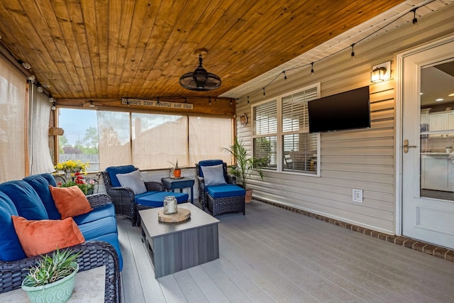sunroom with a wealth of natural light and outdoor lounge area