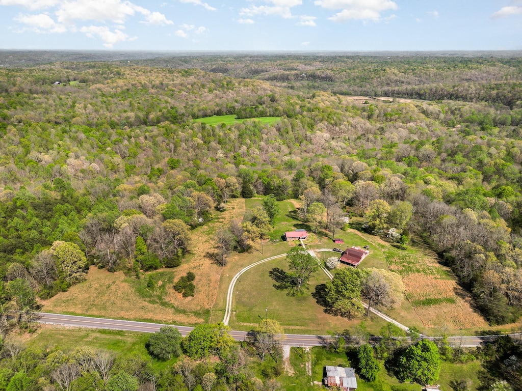 drone / aerial view featuring a forest view