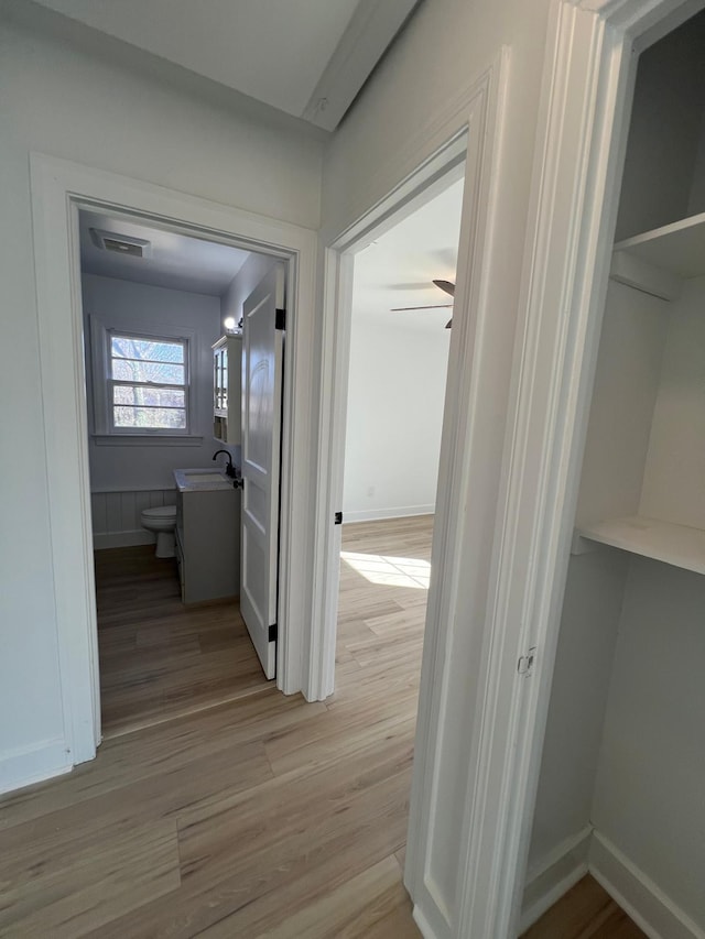 419 Hawkins Ave, Murfreesboro, TN 37130 - hall featuring visible vents, a sink, light wood finished floors, and baseboards