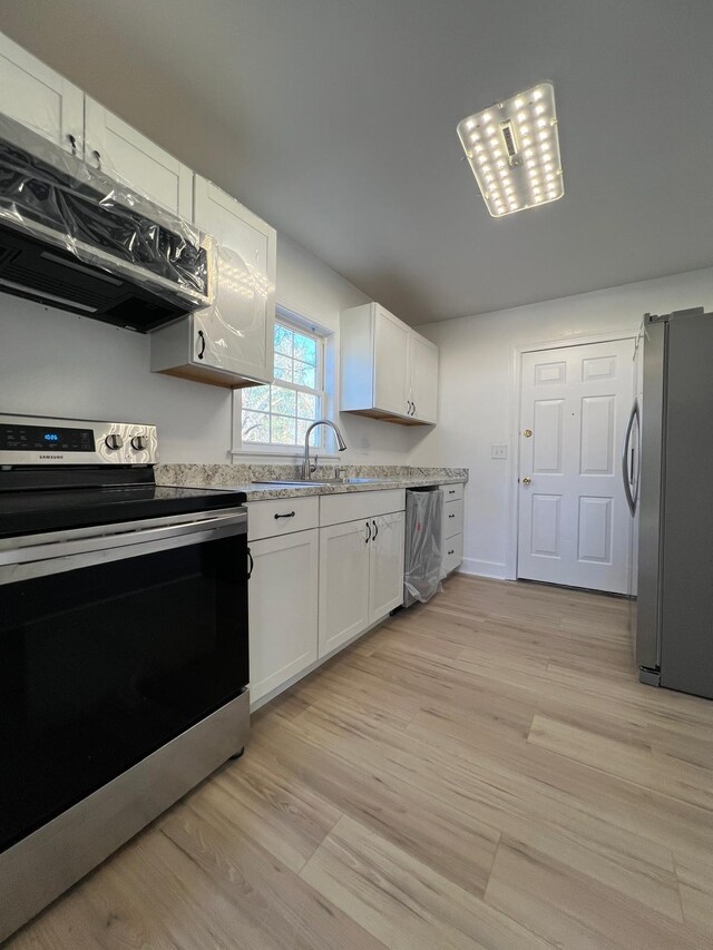 419 Hawkins Ave, Murfreesboro, TN 37130 - kitchen with exhaust hood, white cabinets, a sink, stainless steel appliances, and light wood-type flooring