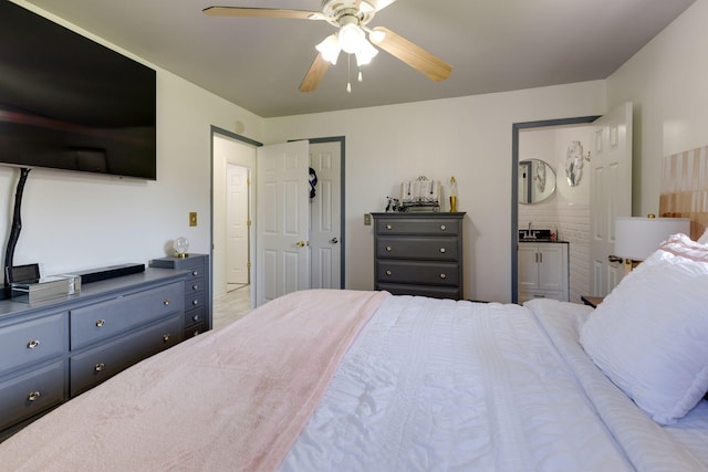 bedroom with a sink, a ceiling fan, and connected bathroom