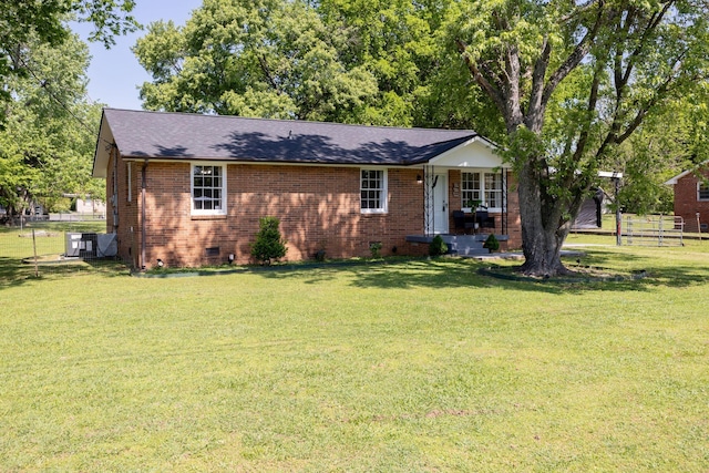 view of front of property with a front lawn, fence, brick siding, a shingled roof, and crawl space