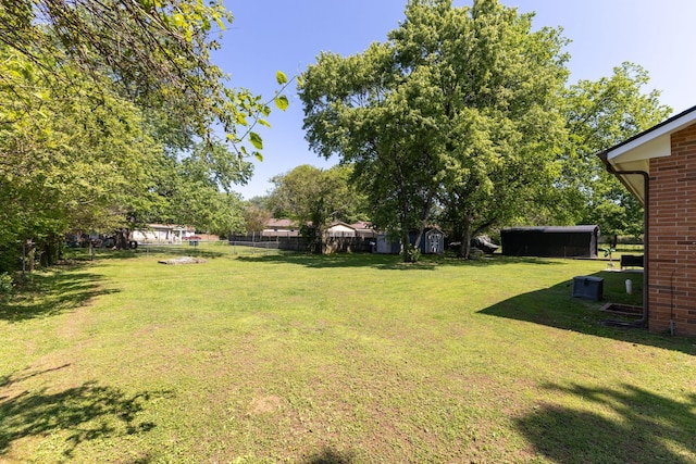 view of yard featuring fence and an outdoor structure