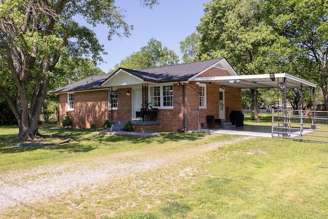 view of front of property featuring driveway, brick siding, fence, a front lawn, and an attached carport