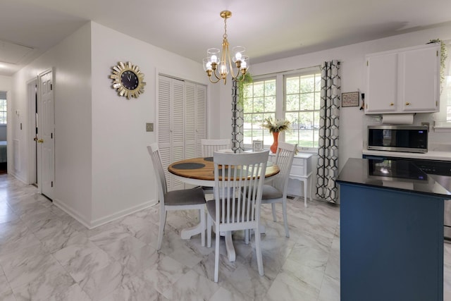 dining room with an inviting chandelier, baseboards, and marble finish floor