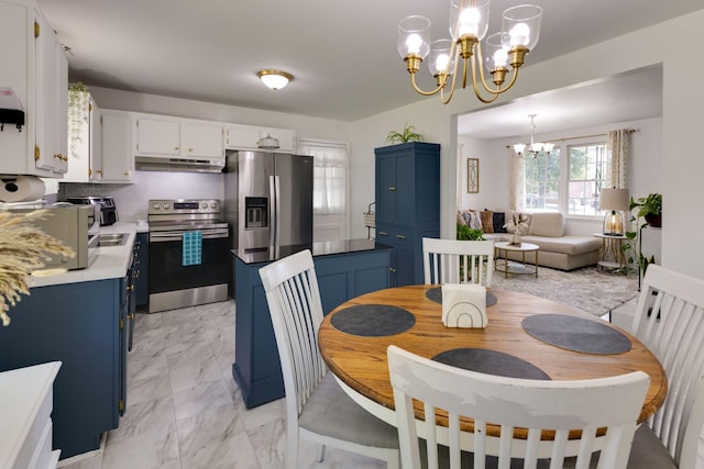dining area featuring a chandelier and marble finish floor