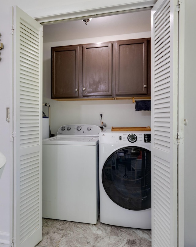 laundry room featuring cabinet space and washer and clothes dryer