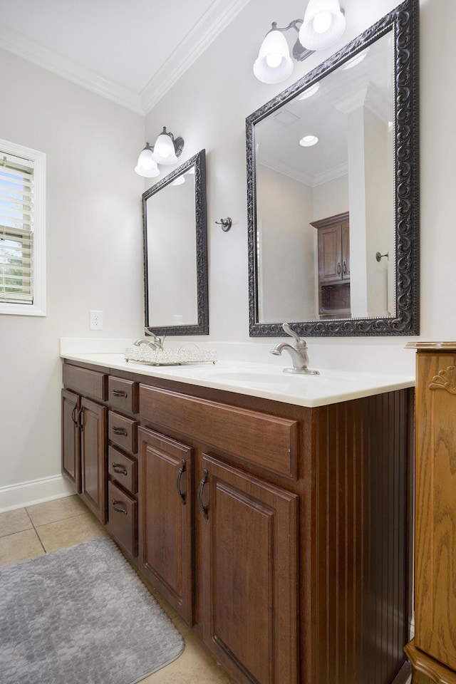 bathroom featuring crown molding, tile patterned floors, baseboards, and vanity