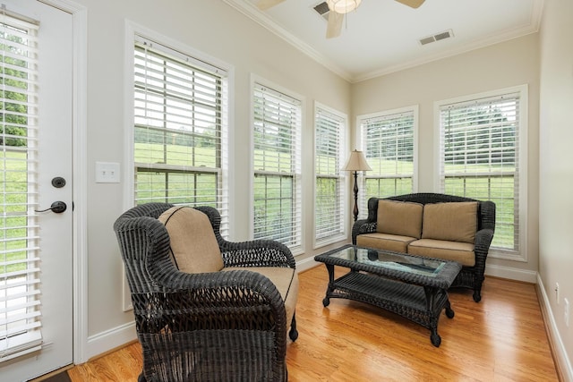 living area with ceiling fan, visible vents, and a healthy amount of sunlight