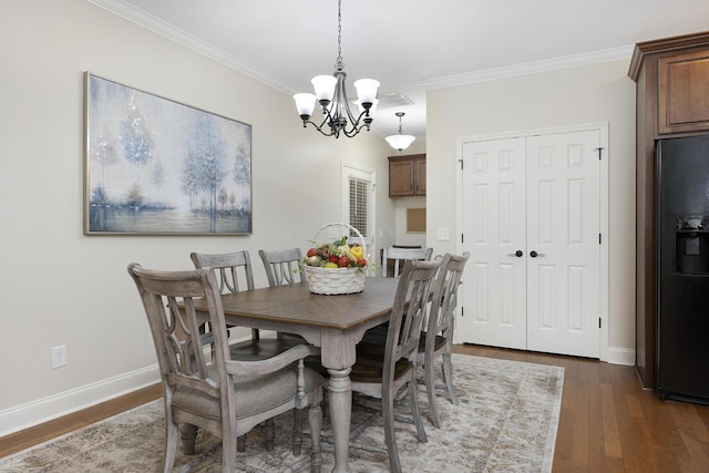 dining area featuring crown molding, baseboards, an inviting chandelier, and dark wood-type flooring