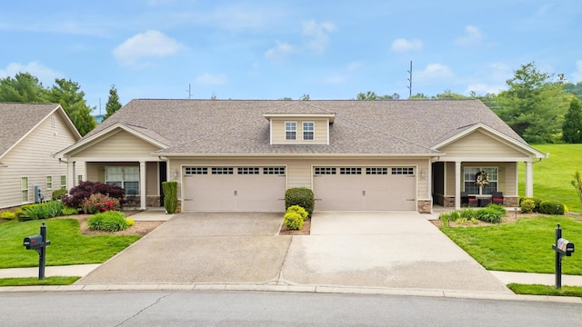 view of front of property with a porch, driveway, a front lawn, an attached garage, and stone siding