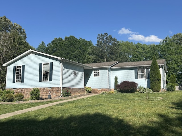 manufactured / mobile home with a front lawn and crawl space