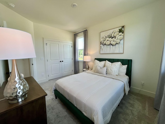 bedroom with a closet, baseboards, and carpet flooring